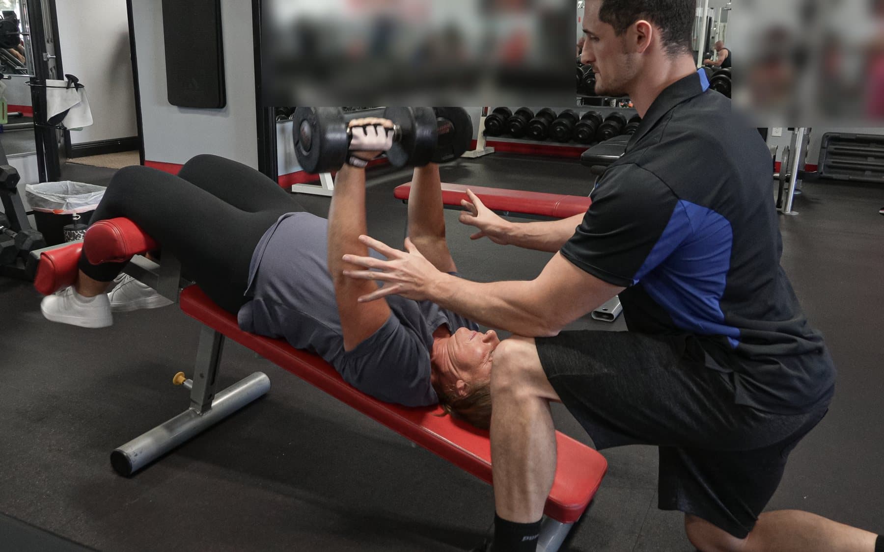 Rob Amoroso spotting a client through a set at Patriot Fitness, Sarasota